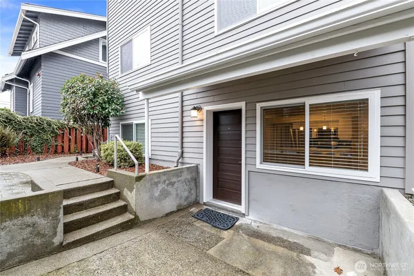 a view of a house with a patio and a yard