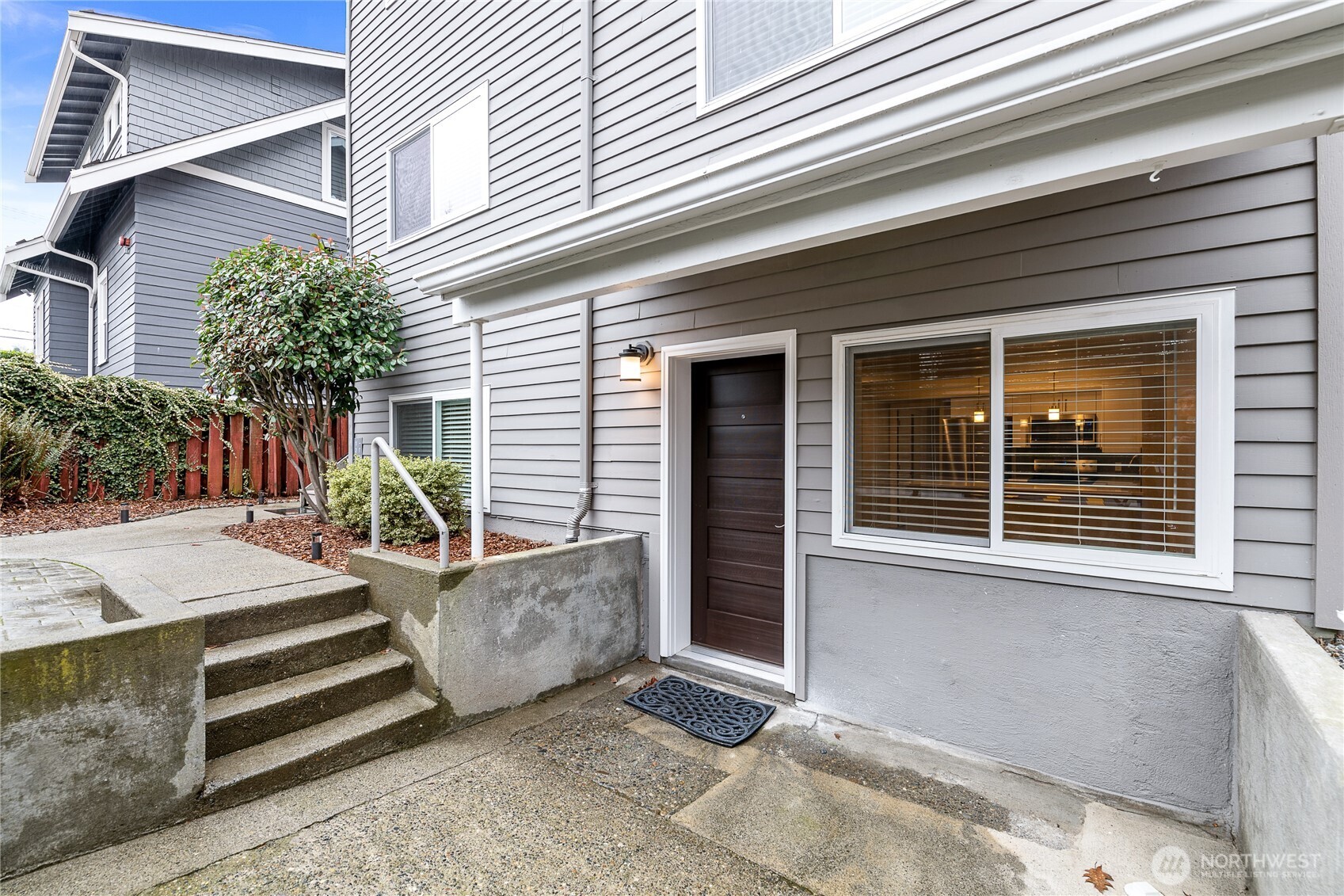 808 Northwest Market Street Seattle, WA 98107 - Photo 4 of 18 a view of a house with a patio and a yard