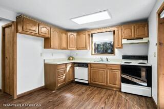 41 Crest View Road Lake Ariel, PA 18436 - Photo 38 of 54 a kitchen with stainless steel appliances granite countertop a stove a sink and a microwave
