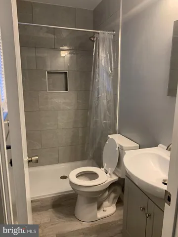 a white toilet sitting next to a bath tub