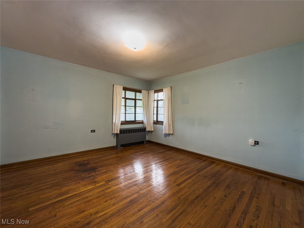 3356 Waterloo Road Mogadore, OH 44260 - Photo 11 of 24 Bedroom with radiator, baseboards, and dark wood-style flooring