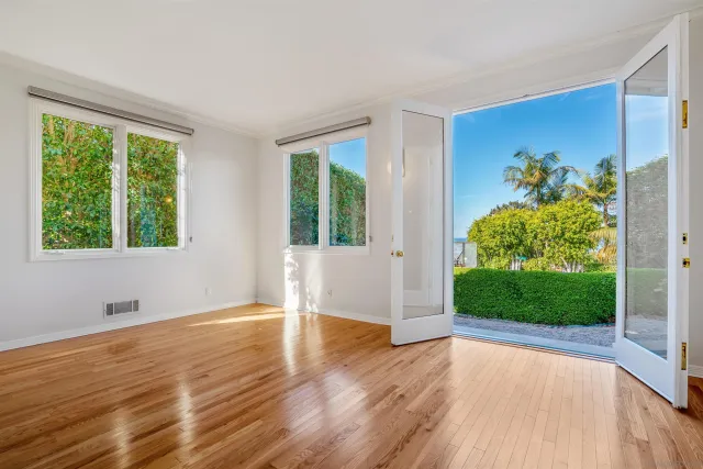 a view of a room with wooden floor and window