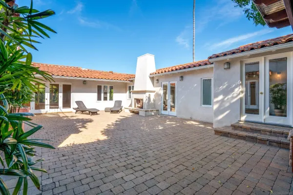 a view of a house with backyard and sitting area