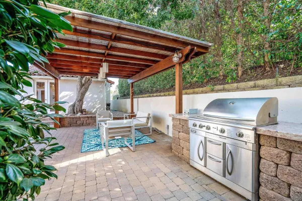 a view of patio with a table and chairs under an umbrella