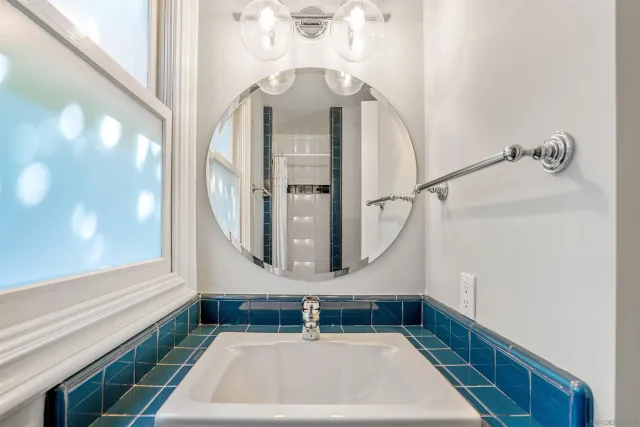a bathroom with a sink a mirror and vanity