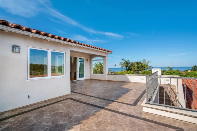 a view of backyard with deck and outdoor seating