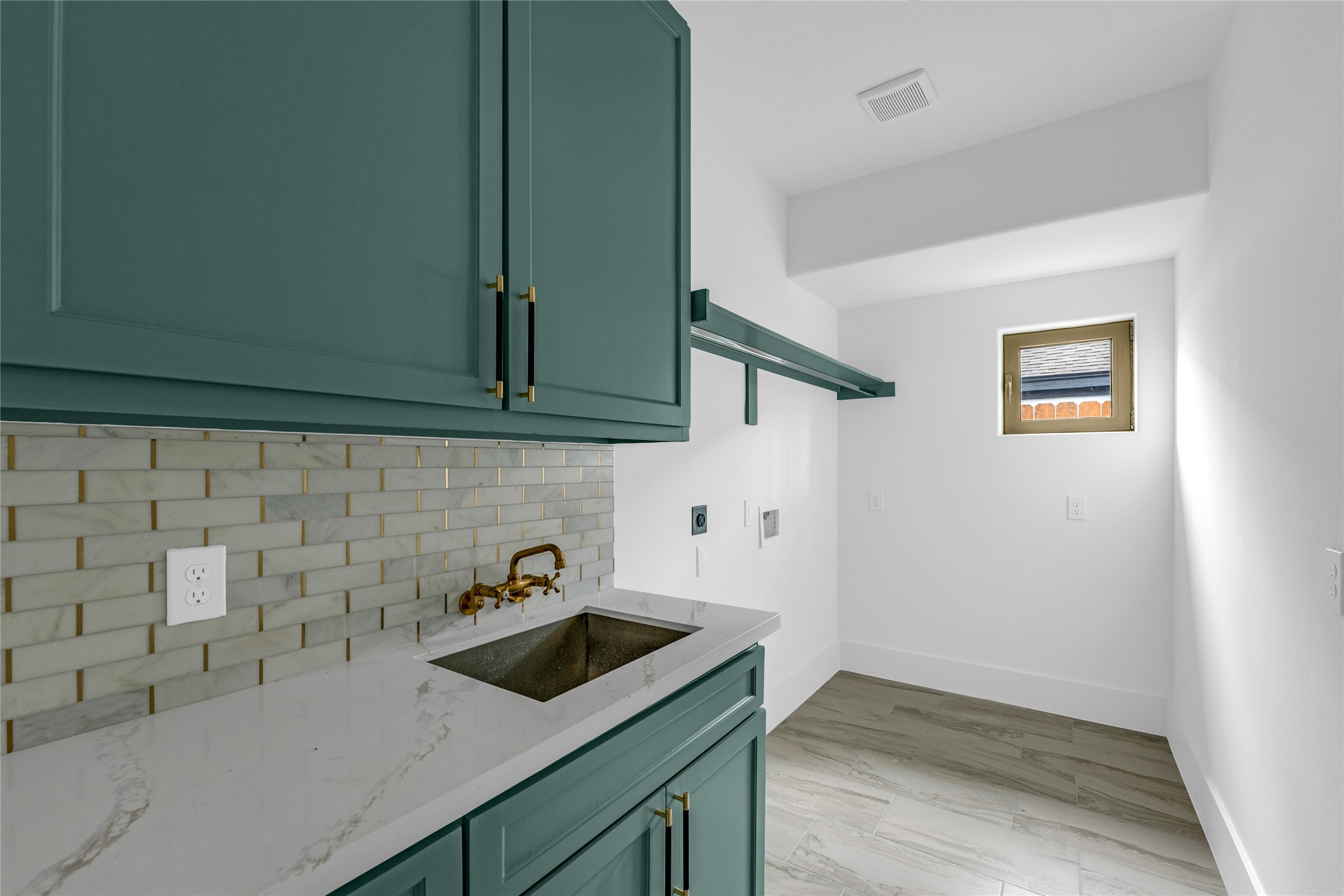 2031 Peppermill Road Houston, TX 77080 - Photo 20 of 48 With lots of cabinet space and a handy utility sink, this bright and stylish laundry room is as functional as it is beautiful.