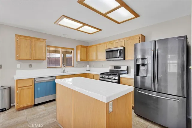 a kitchen with stainless steel appliances a stove cabinets and a sink