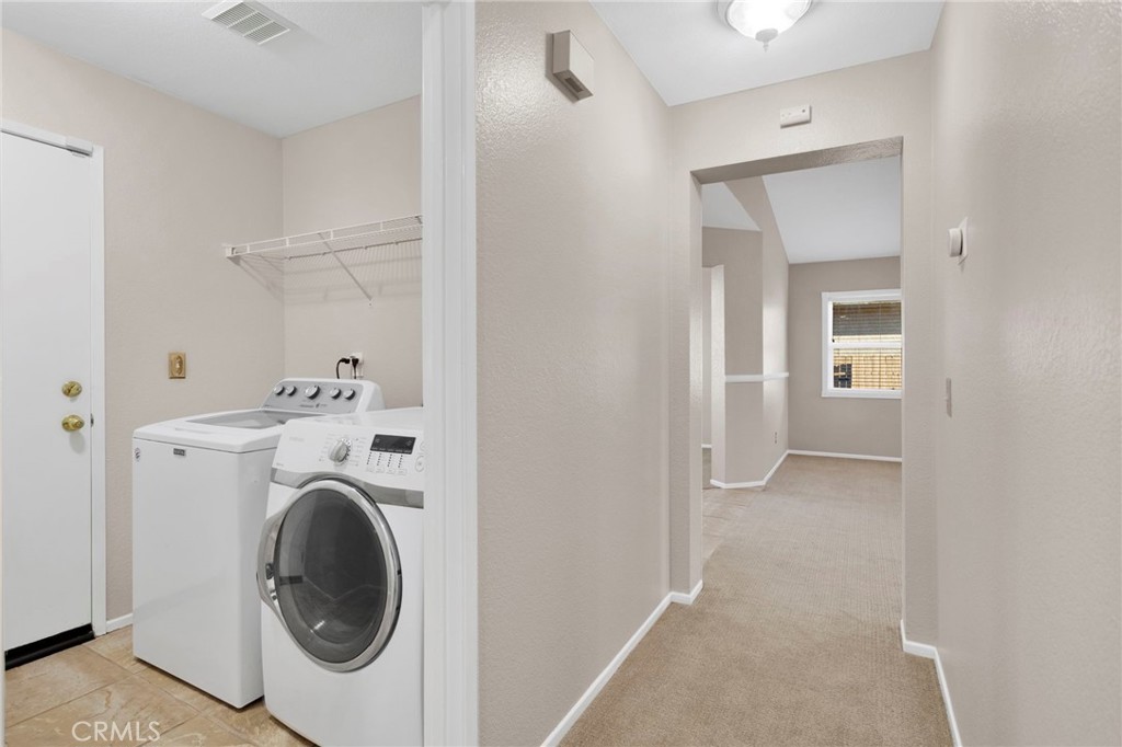 11979 Luna Road Victorville, CA 92392 - Photo 23 of 49 a view of a hallway with washer and dryer