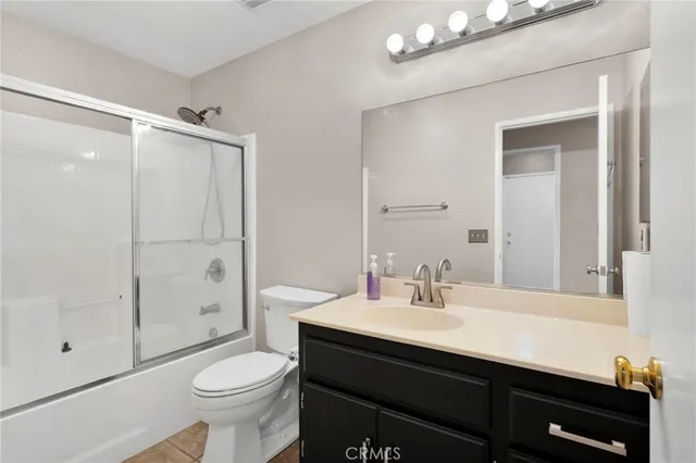 a bathroom with a sink vanity mirror and toilet