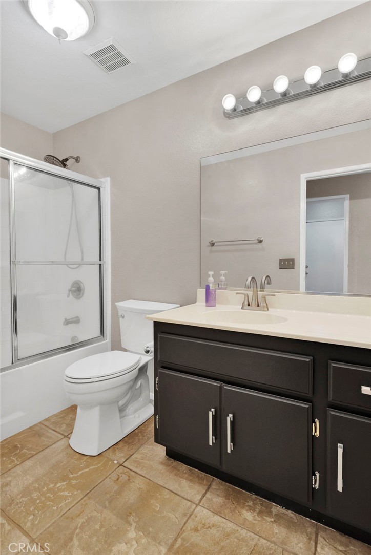 11979 Luna Road Victorville, CA 92392 - Photo 26 of 49 a bathroom with a sink vanity mirror and toilet