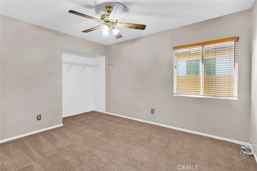 11979 Luna Road Victorville, CA 92392 - Photo 29 of 49 an empty room with a window and a fan