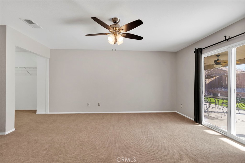 11979 Luna Road Victorville, CA 92392 - Photo 41 of 49 an empty room with window and ceiling fan