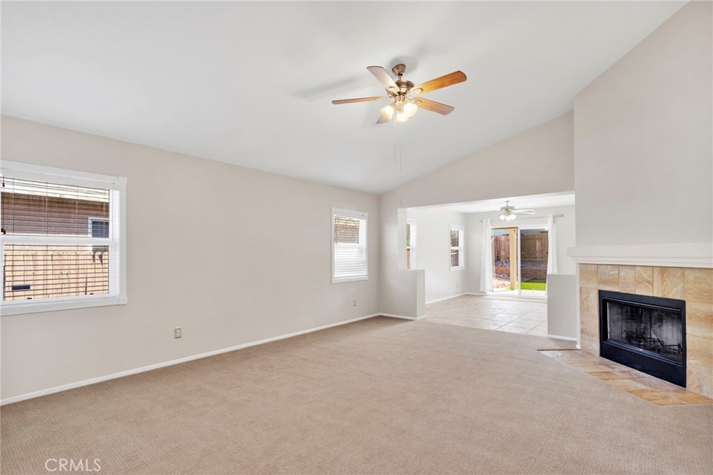 11979 Luna Road Victorville, CA 92392 - Photo 6 of 49 a view of an empty room with a window and fireplace