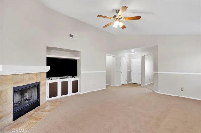 a view of a kitchen with granite countertop a sink cabinets and stainless steel appliances