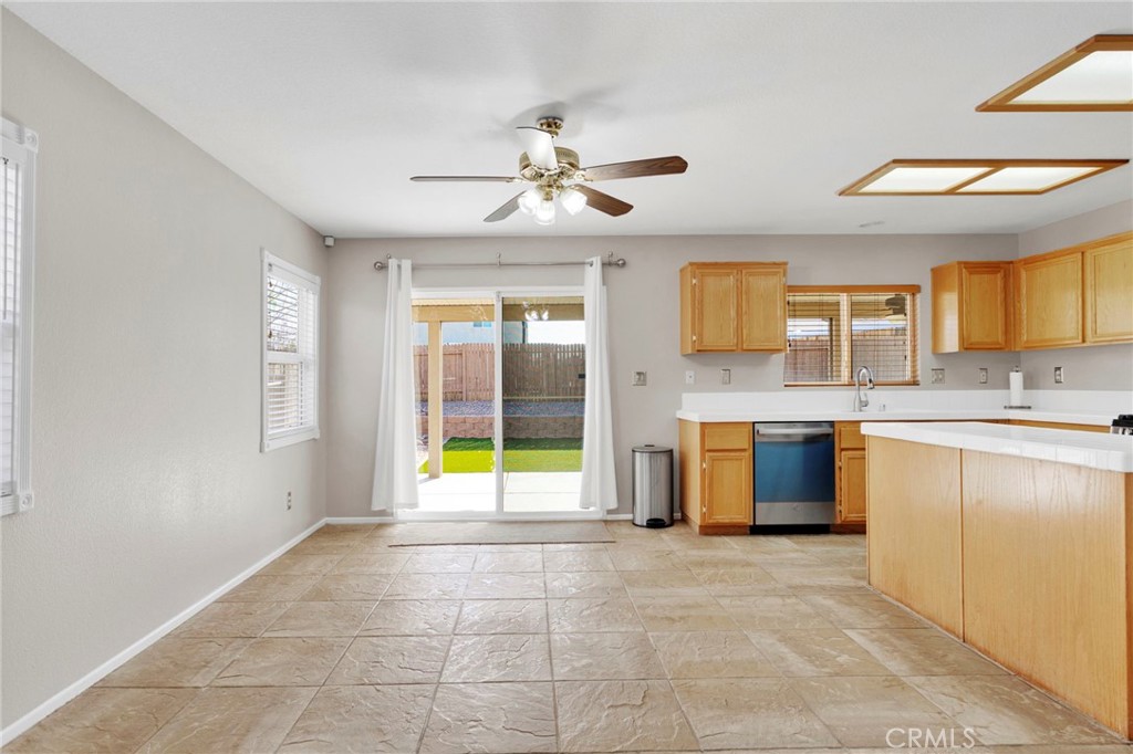 11979 Luna Road Victorville, CA 92392 - Photo 10 of 49 a view of a kitchen with granite countertop a sink cabinets and stainless steel appliances