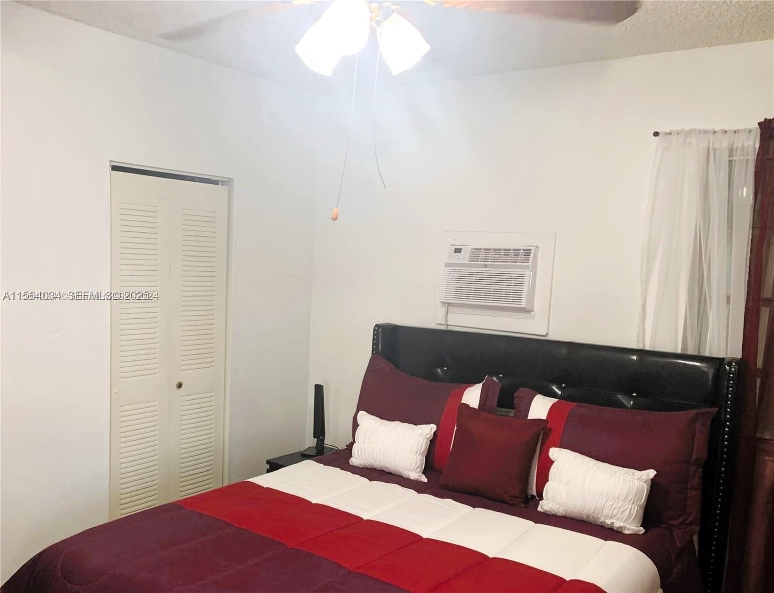 662 East 21st Street Hialeah, FL 33013 - Photo 6 of 21 a bedroom with a bed and a window
