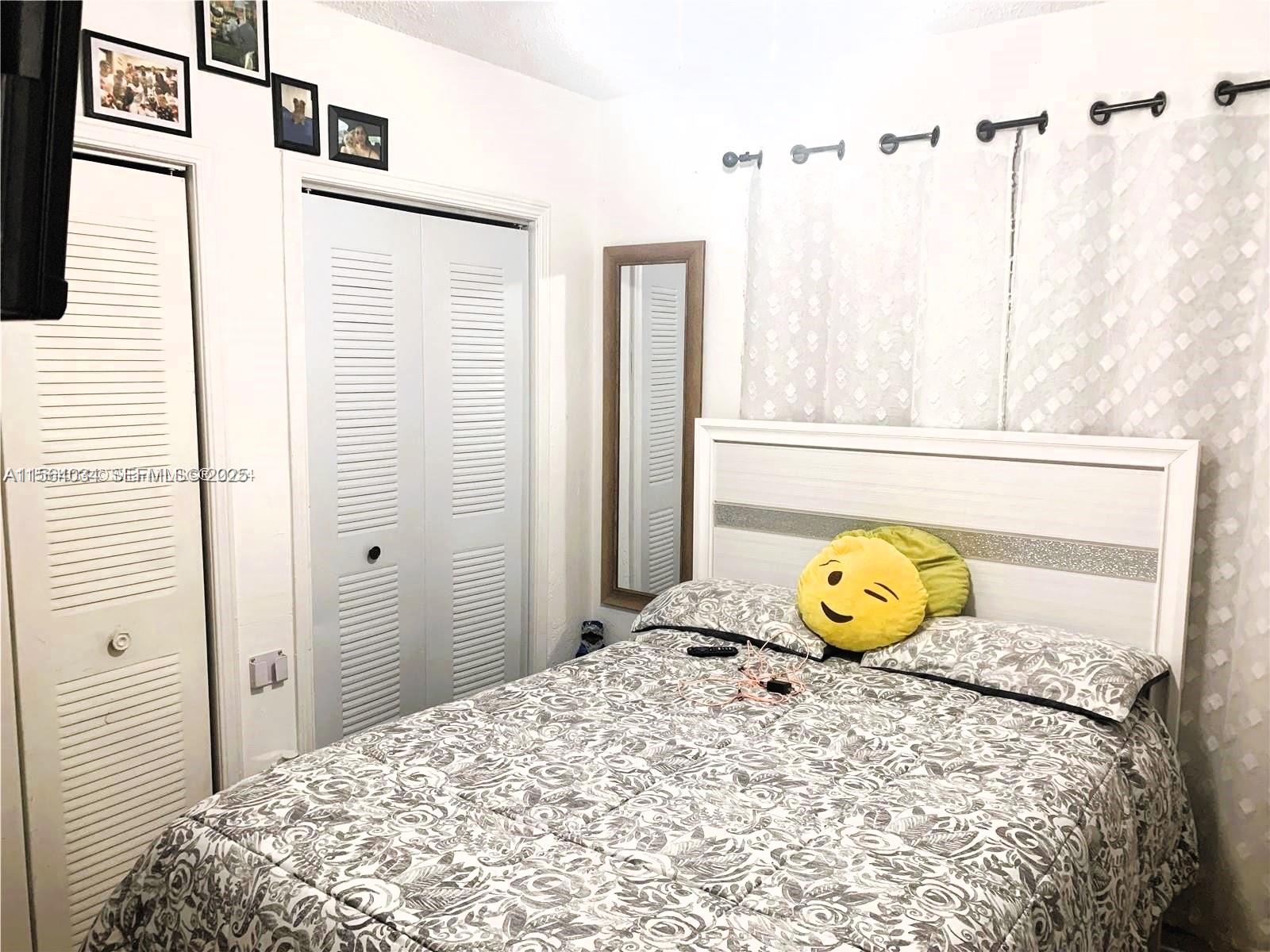 662 East 21st Street Hialeah, FL 33013 - Photo 9 of 21 a bedroom with a bed and a window