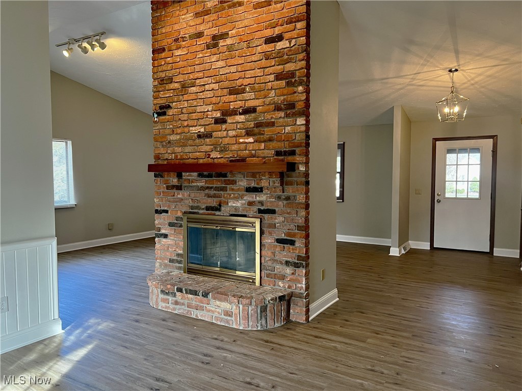 89 Bowhall Road Painesville, OH 44077 - Photo 7 of 23 Dramatic vaulted ceiling with 2 story brick faced wood burning fireplace