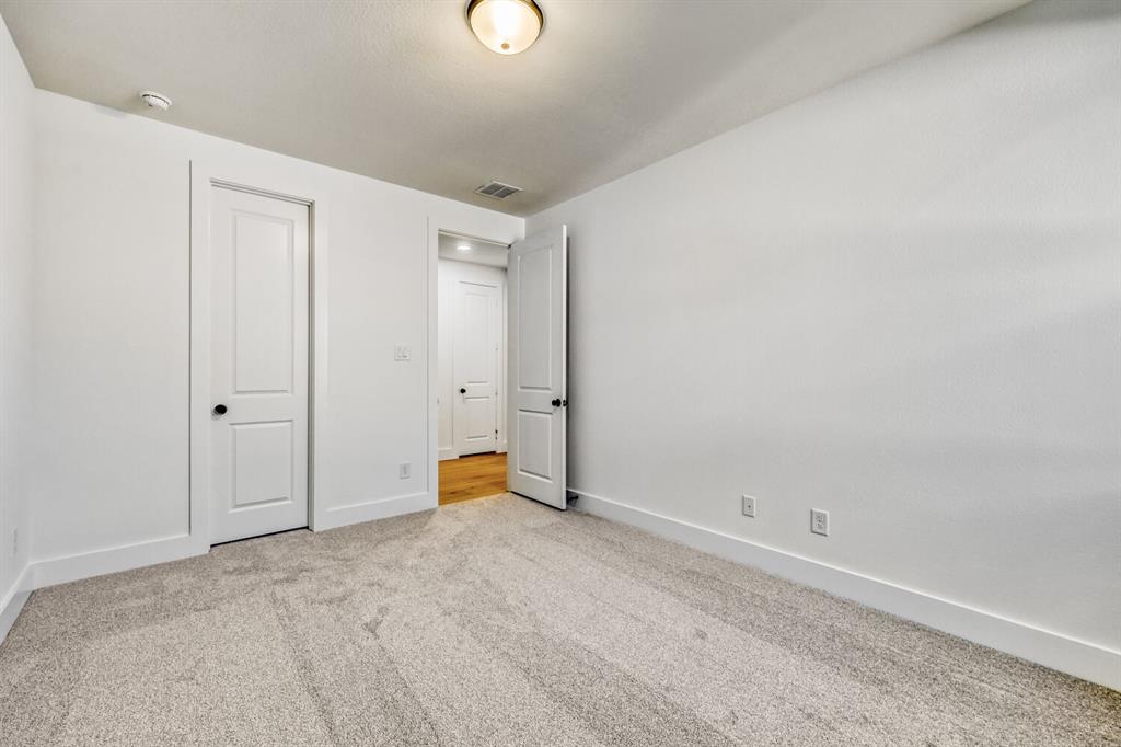 147 Derrett Lane Rhome, TX 76078 - Photo 10 of 28 Unfurnished bedroom featuring light carpet and baseboards