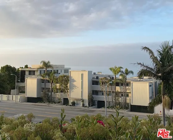 a room with pool table and potted plants