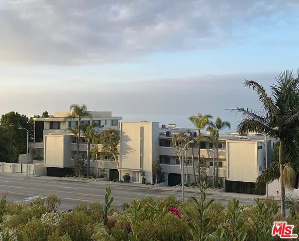 a room with pool table and potted plants