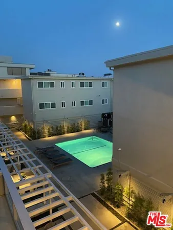 a roof deck with a table and chairs under an umbrella