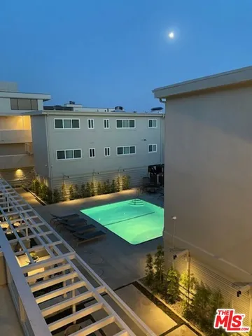 a roof deck with a table and chairs under an umbrella