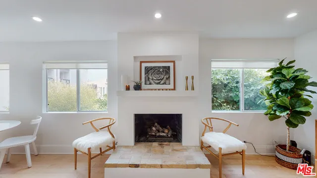 a living room with furniture a window and a fireplace