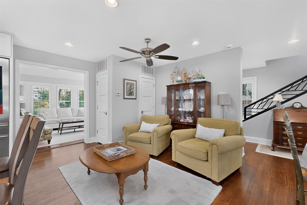4548 Roland Avenue, Unit A Dallas, TX 75219 - Photo 16 of 31 Bright, open living area featuring hardwood flooring, a ceiling fan with brushed nickel finish, recessed lighting, and French doors with transom windows providing natural light