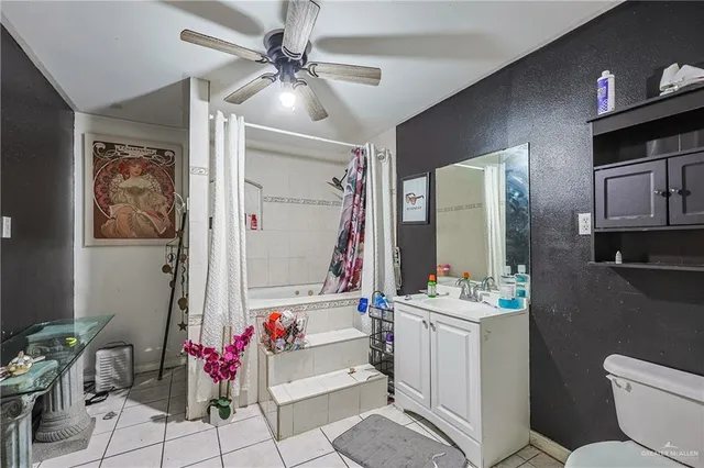 a bathroom with a sink vanity mirror and toilet