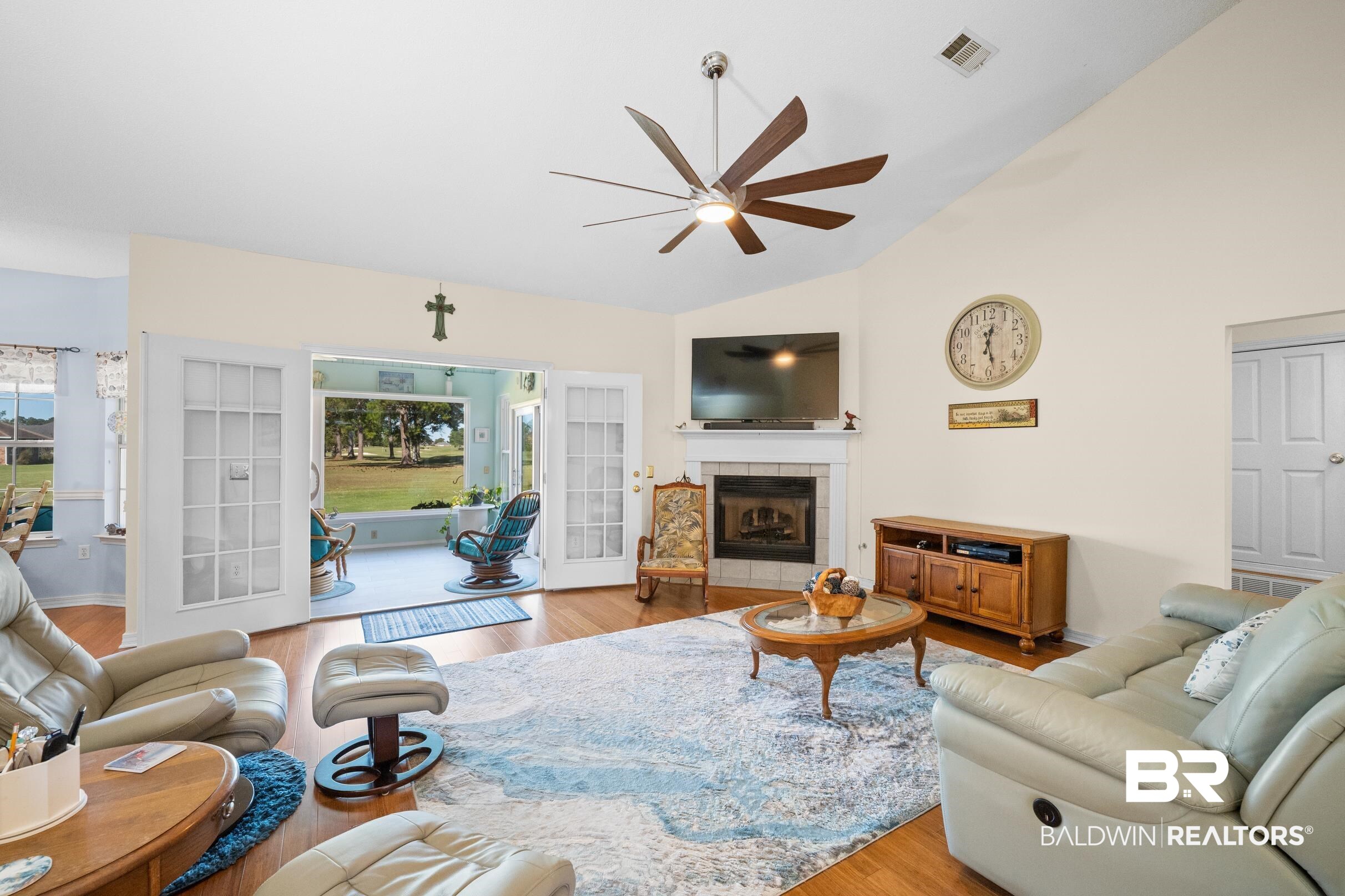 22355 East County Road 12 Foley, AL 36535 - Photo 4 of 54 Living room with light wood-style flooring, vaulted ceiling, a tile fireplace, and ceiling fan
