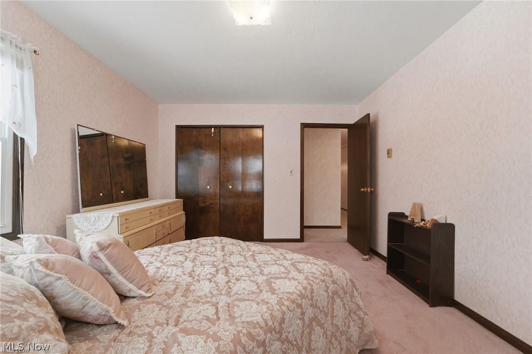 17452 Huntley Road Windsor, OH 44099 - Photo 32 of 49 Bedroom with a closet and light colored carpet