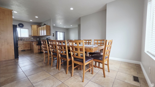 1437 925 South Vernal, UT 84078 - Photo 8 of 47 Open-concept living area featuring light-toned tile flooring, recessed lighting, and a kitchen with light wood cabinetry and granite-style countertops