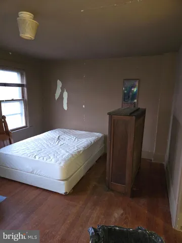 a bedroom with a bed and a lamp with window