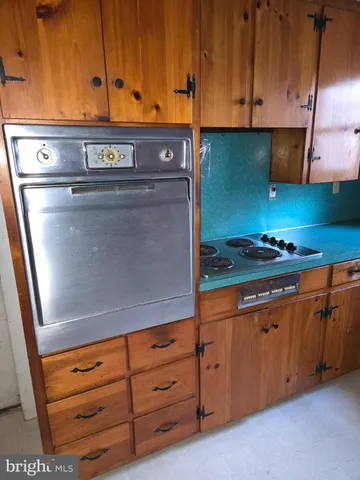 a kitchen with granite countertop a stove and cabinets