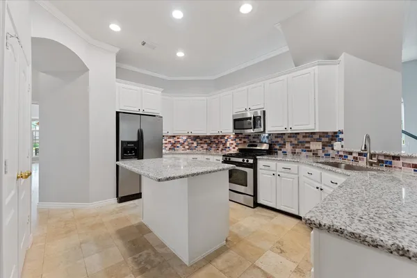 an empty room with ceiling fan and window