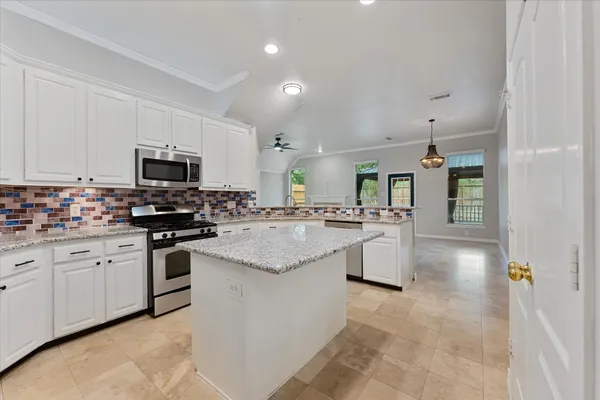 a bathroom with a toilet a sink and shower