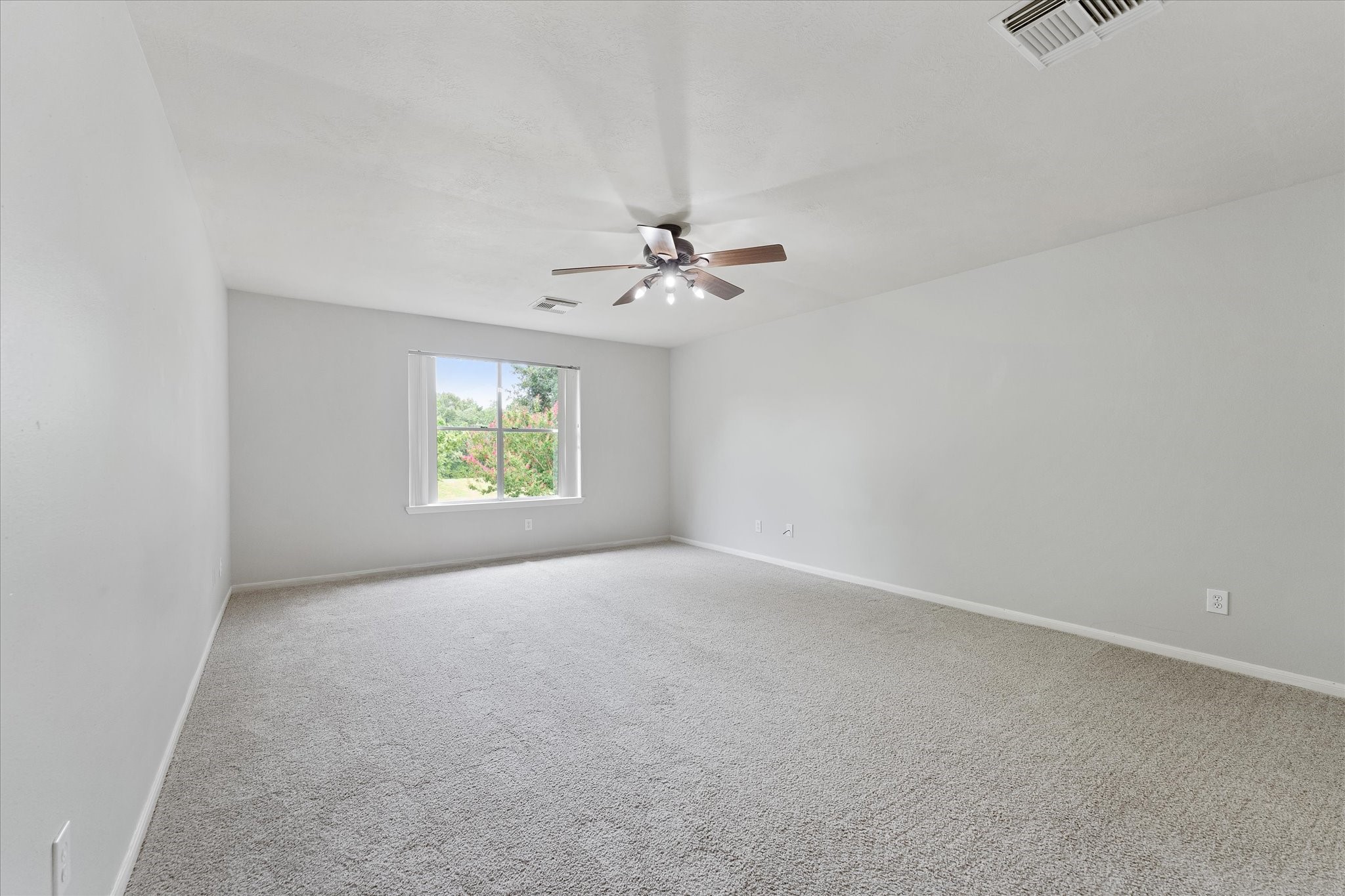 29823 Spring Terrace Drive Spring, TX 77386 - Photo 39 of 49 an empty room with windows and chandelier fan