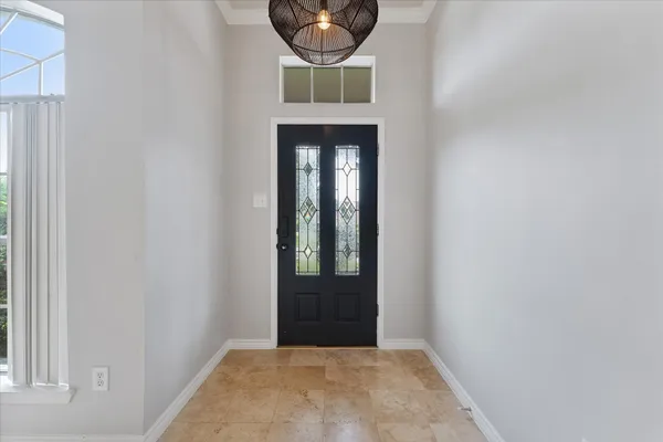 an empty room with ceiling fan and window