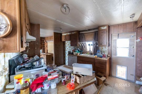 1142 South Guam Street Ridgecrest, CA 93555 - Photo 8 of 16 a room with furniture a rug toys and a window
