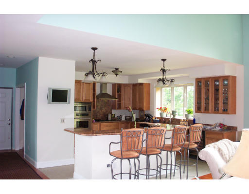 3235 Mountain Road Suffield, CT 06093 - Photo 3 of 11 a living room with furniture a flat screen tv and kitchen view