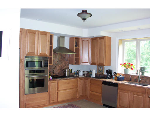 3235 Mountain Road Suffield, CT 06093 - Photo 4 of 11 a kitchen with kitchen island granite countertop a stove cabinets and stainless steel appliances