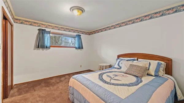 front view of a house with a large tree