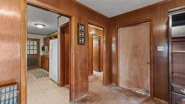 a dining room with furniture a chandelier and wooden floor