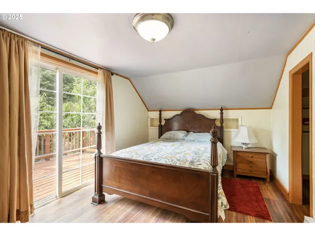 a view of a bedroom with wooden floor and closet
