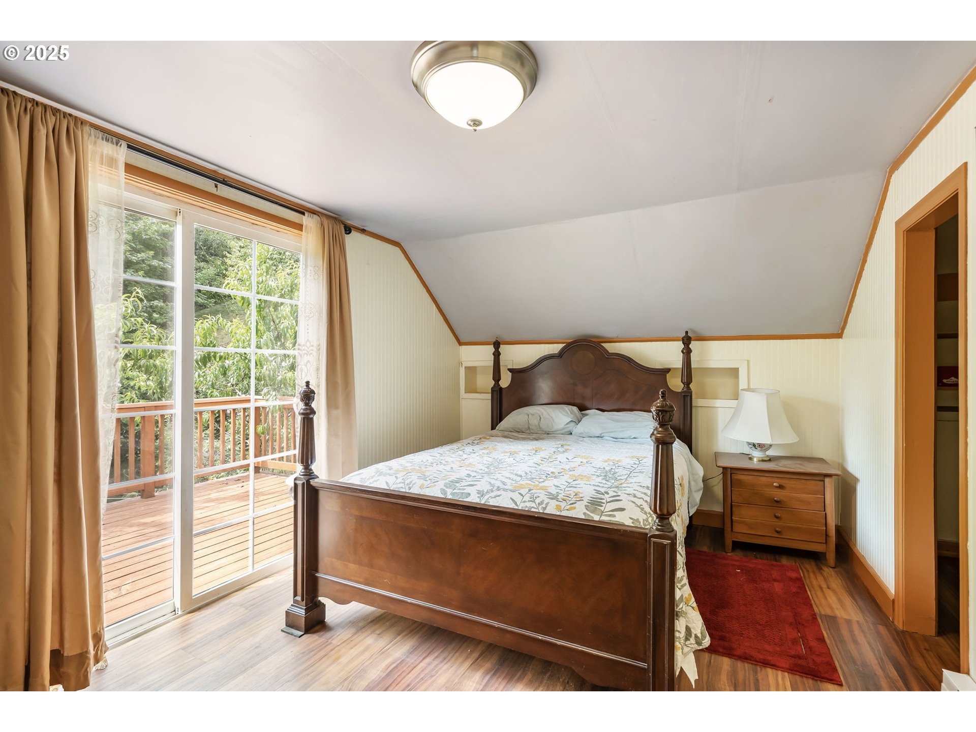 51557 Southwest Em Watts Road Scappoose, OR 97056 - Photo 22 of 40 a bedroom with a bed and a large window