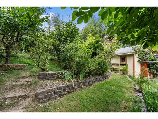 a view of backyard with a deck and a garden