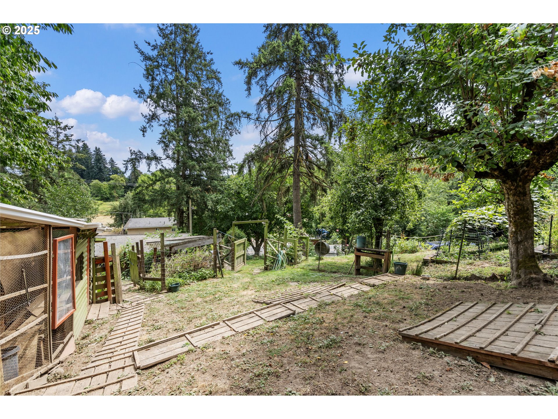 51557 Southwest Em Watts Road Scappoose, OR 97056 - Photo 32 of 40 a view of a yard with a house