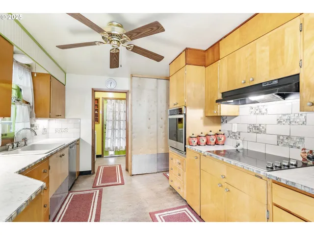 a bathroom with a granite countertop sink and a large mirror